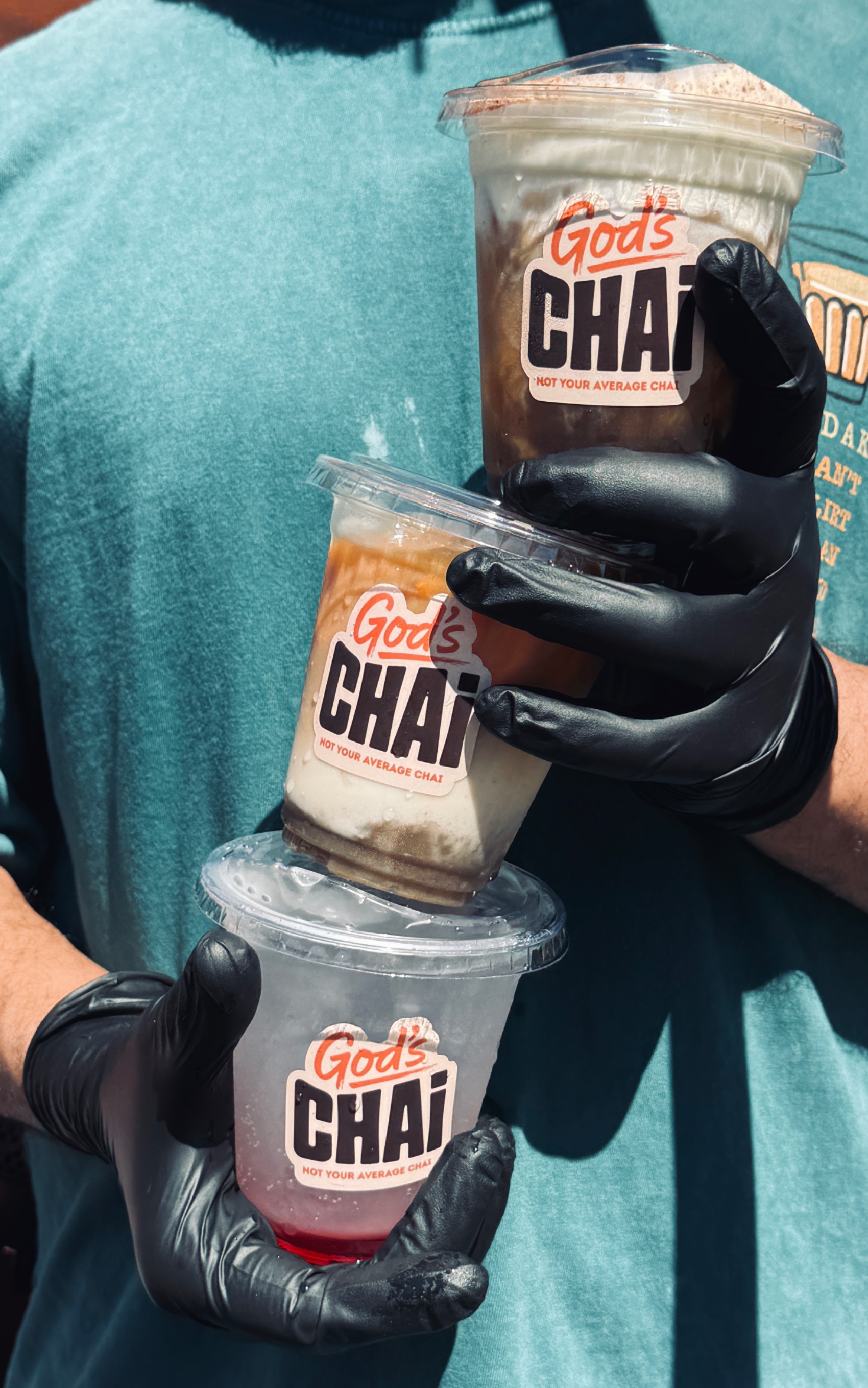 Three God's Chai cups held stacked at the cart